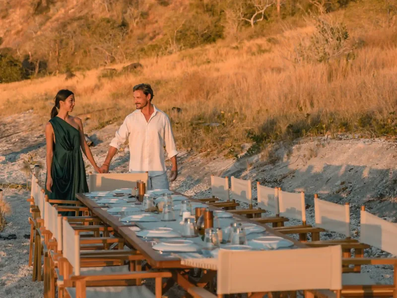 Private dinner table set up on a beach in Komodo