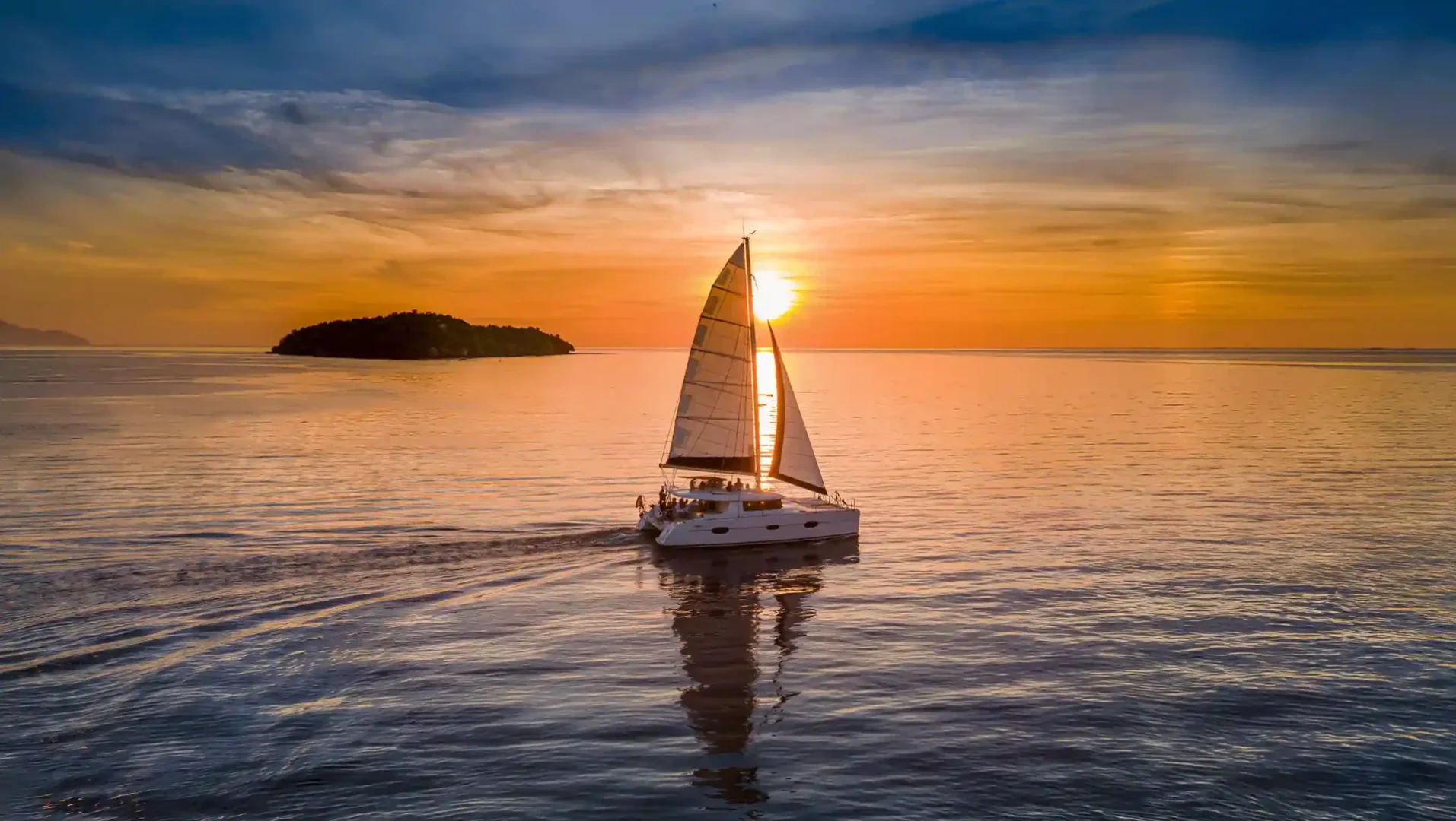 Catamaran sailing at sunset in Komodo