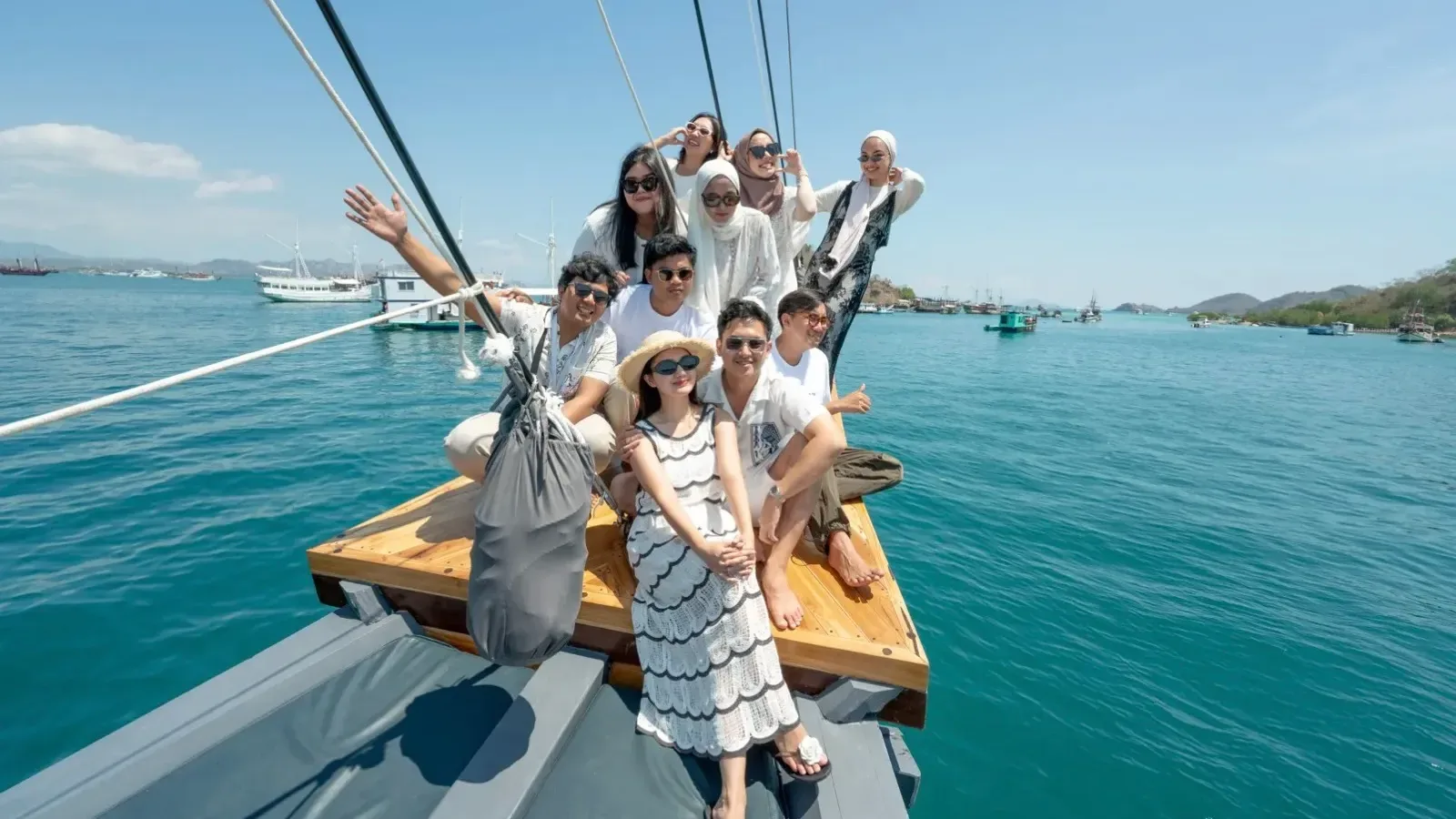Guests on the bow of a phinisi in Komodo