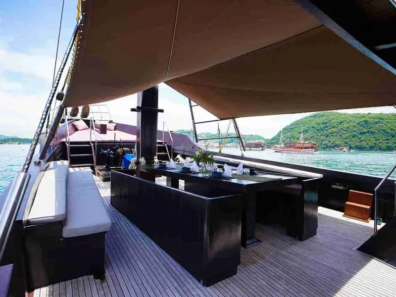 Outdoor dining area on the deck of a phinisi