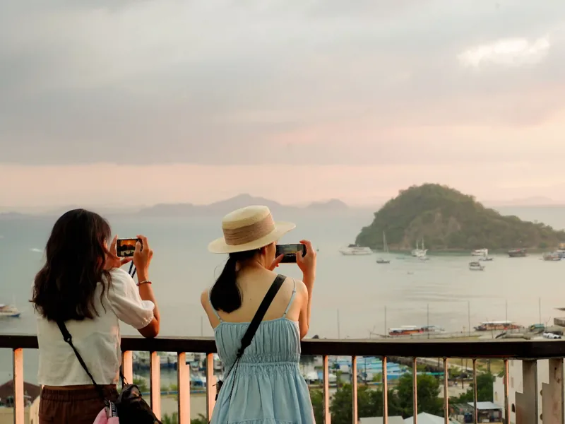 Travellers photographing the view over Labuan Bajo